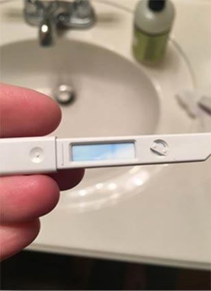 This is a pregnancy test that includes urine sample collection media.