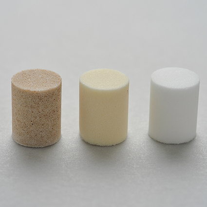 Three chromatography frits sitting on a table